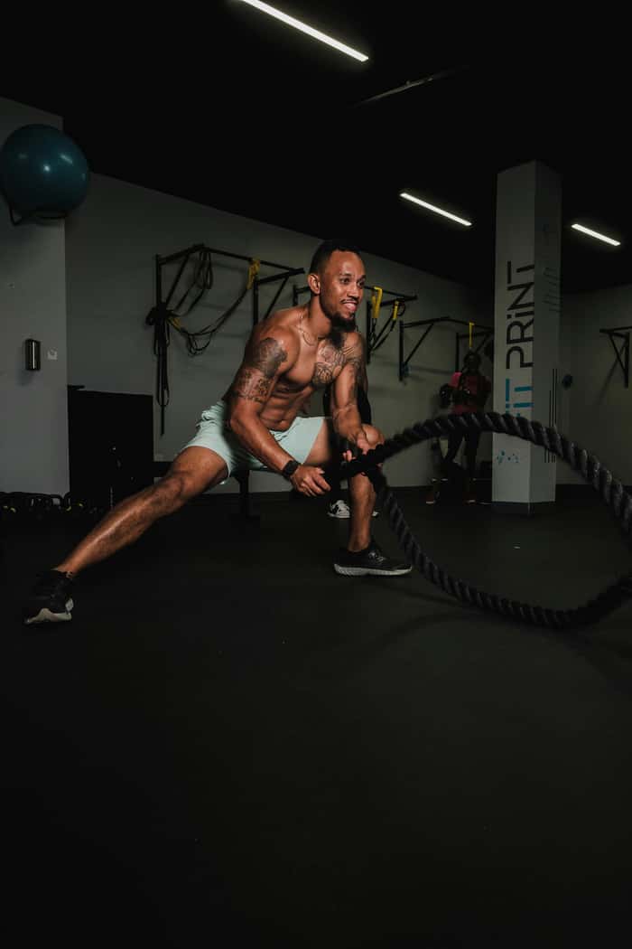 Man battling ropes during a workout.